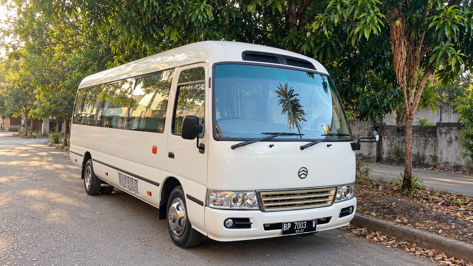 White Coaster Joylong, 26 passenger seats, full vehicle in landscape view.