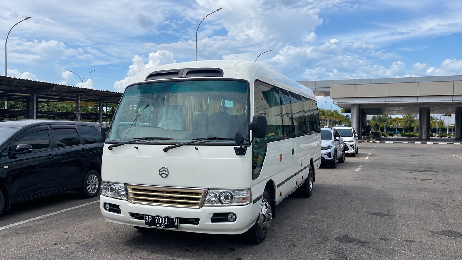 White minibus in a Batam pickup area.